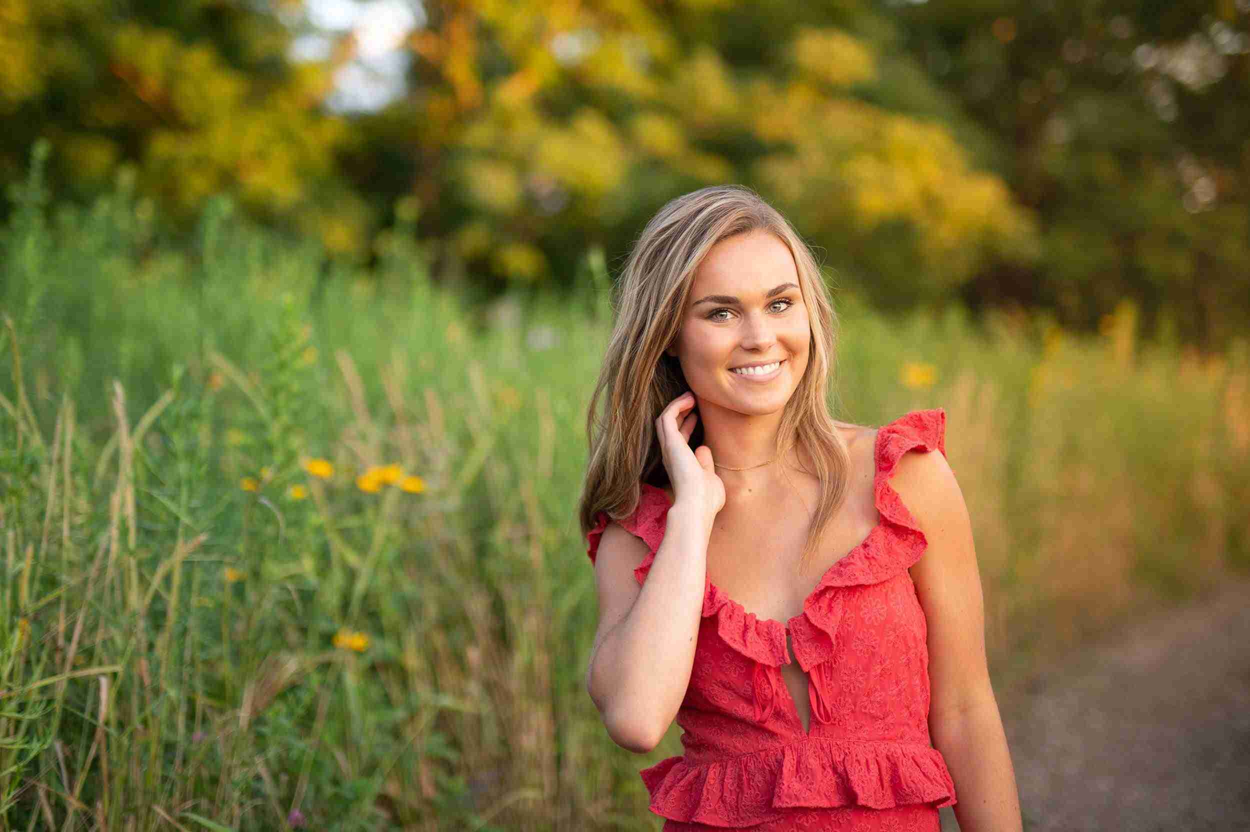 Girl in red dress standing in a field of flowers