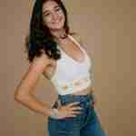 What to Ask Your Senior Photographer Before Booking – senior girl wearing white crochet top on brown studio backdrop – award-winning Chicago senior photographer Shalimar B. Photography.