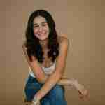 What to Ask Your Senior Photographer Before Booking – senior girl photos in studio wearing white crochet top on tan backdrop– award-winning Chicago senior photographer Shalimar B. Photography.