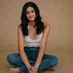 What to Ask Your Senior Photographer Before Booking – senior girl photos in studio wearing white crochet top on tan backdrop– award-winning Chicago senior photographer Shalimar B. Photography.